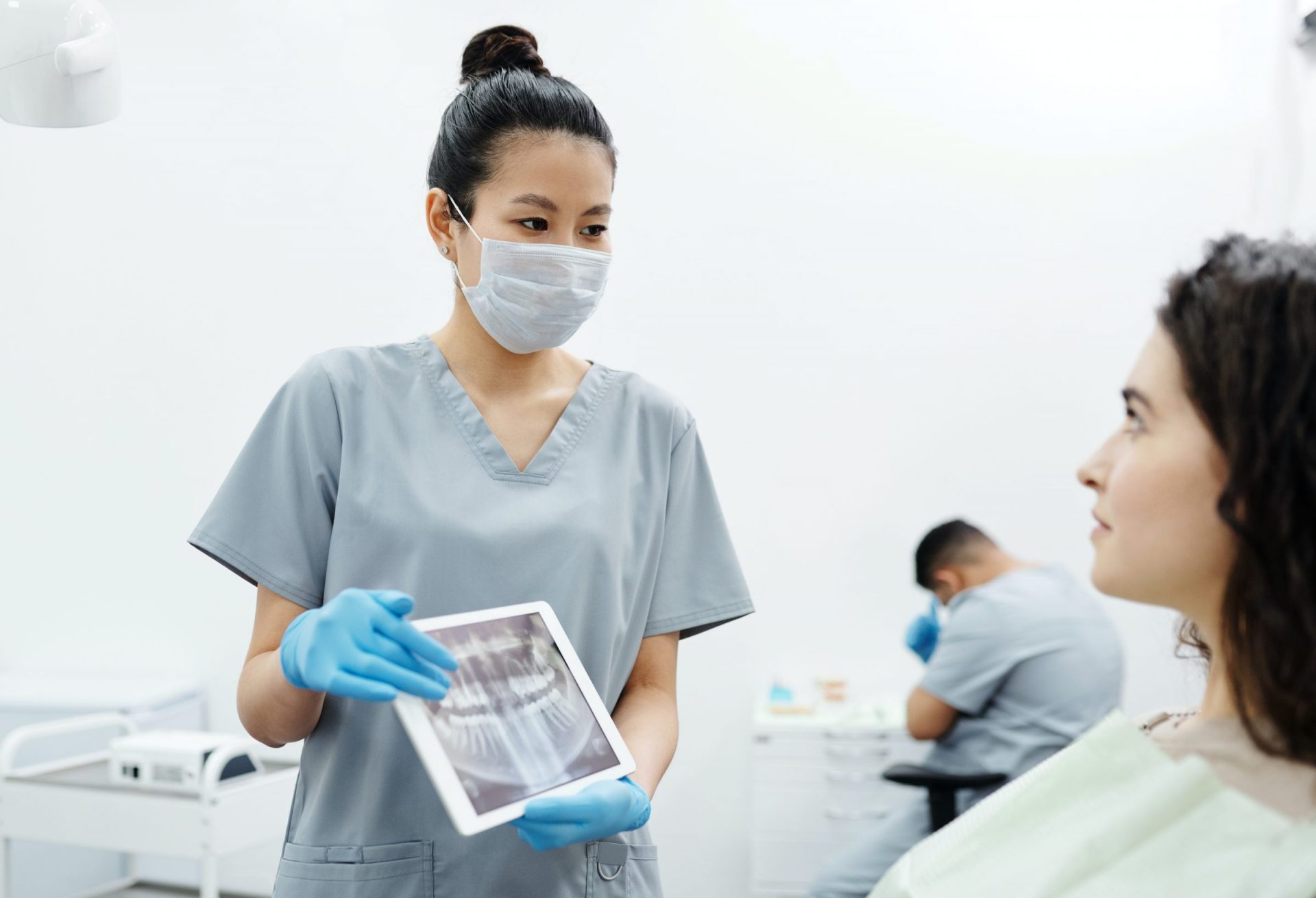 dentist showing x ray image of patients teeth to the patient