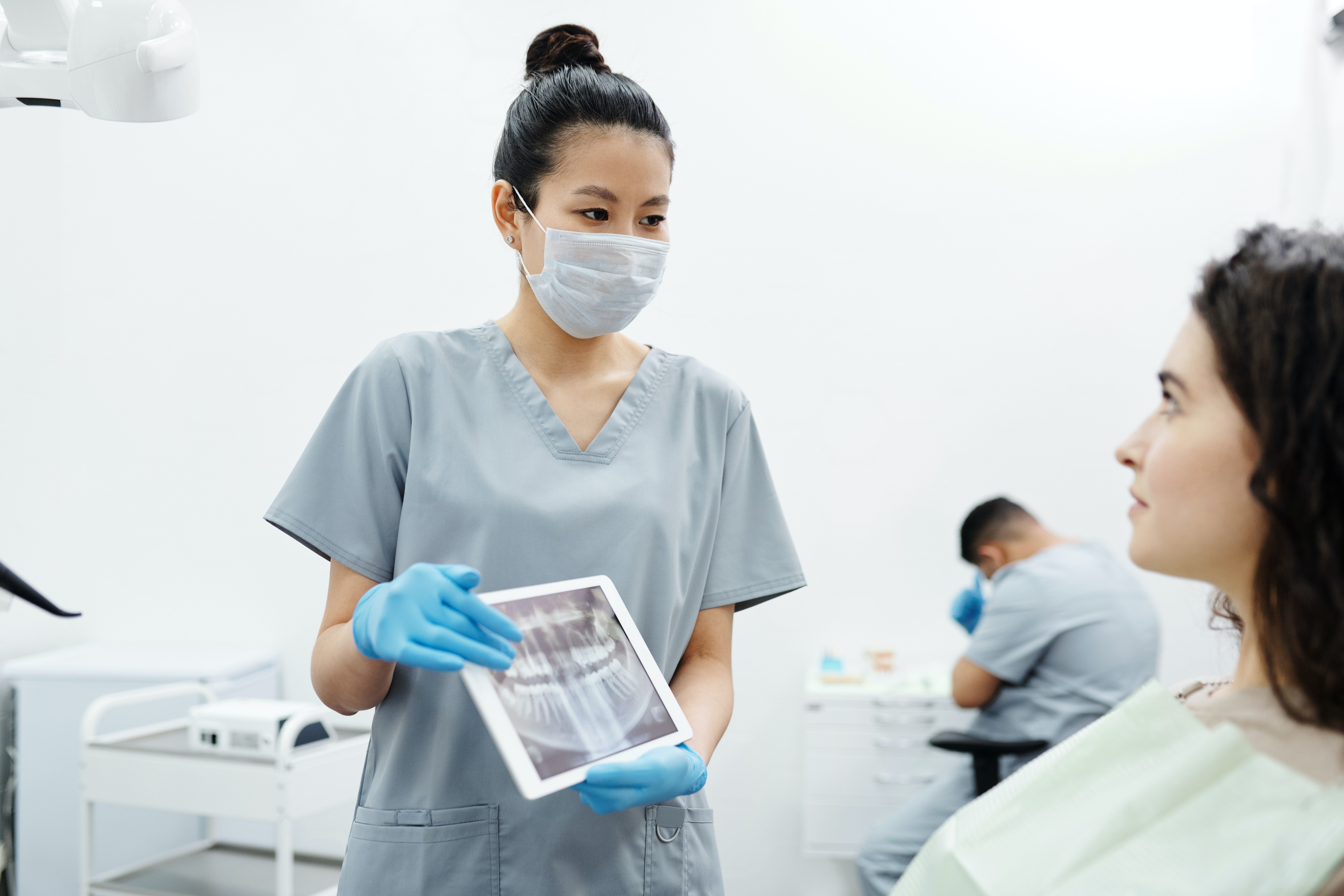 Dentist showing X-ray image of patients teeth to the patient