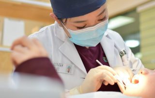 Dentist checking a young patient