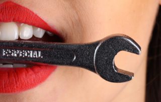 teeth biting on a wrench