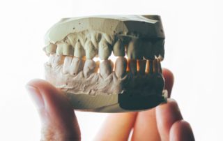 Teeth mold held in hand