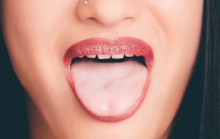 Woman with mouth open and tongue sticking out