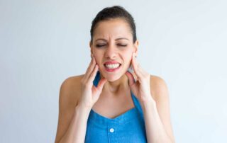 Young woman suffering from tmj