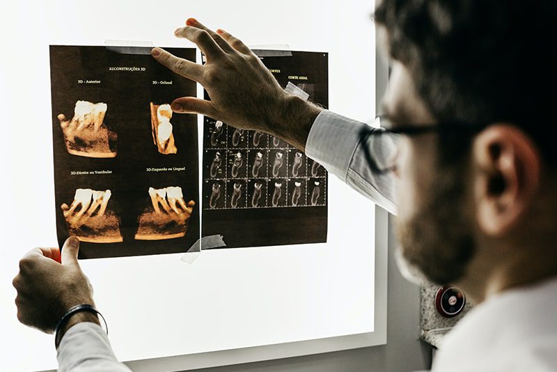Dentist looking at patient X-ray