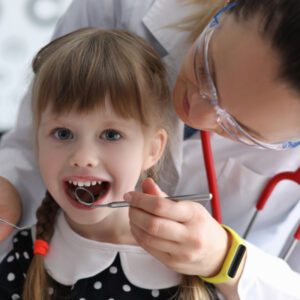 dental tech looking in childs mouth