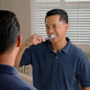 man brushing teeth before work