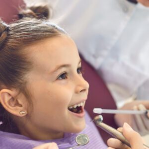 Cute girl getting tooth treatment