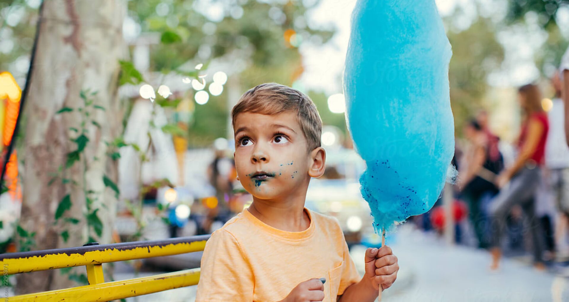 Kid eating candy floss