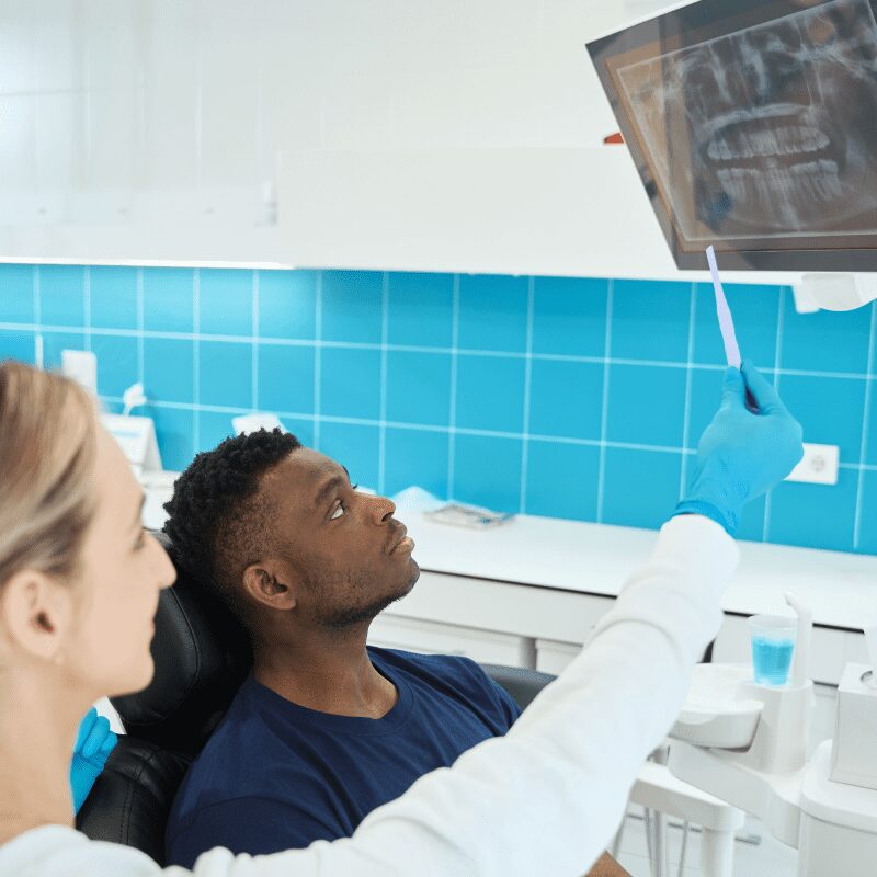 dentist showing patient xrays on the screen dentist, patient, opg, cbct,