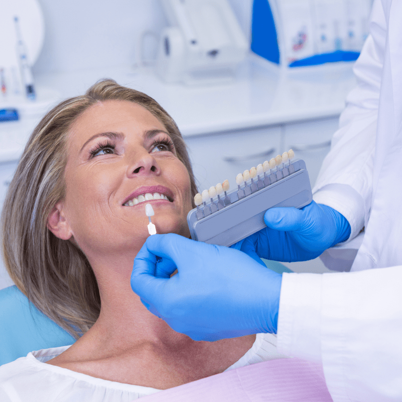 woman consulting dentist about teeth whitening