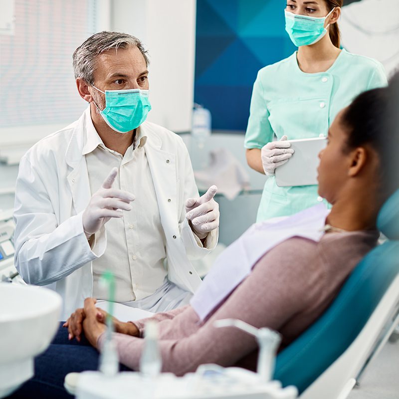 dentist reviewing dental exam with patient