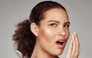 woman doing a bad breath check, medical condition