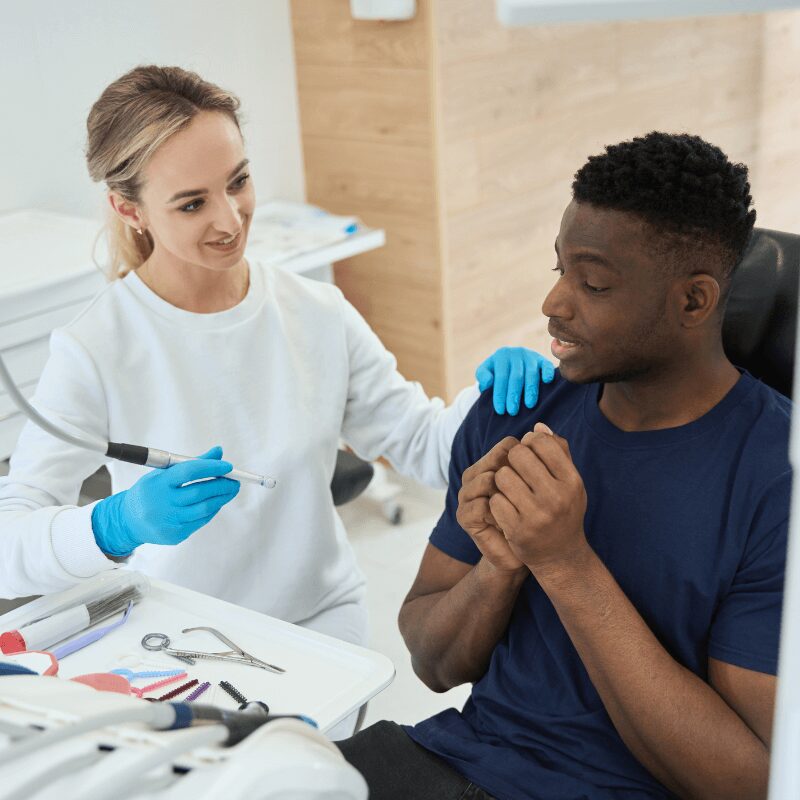 young man asking dental hygienist questions