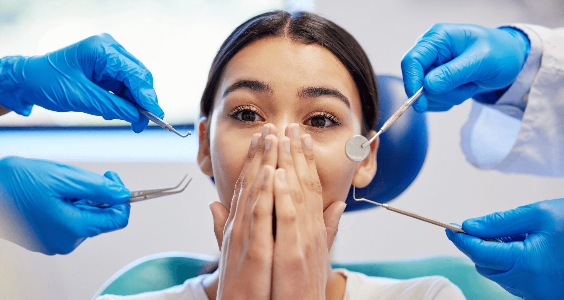 young woman in dental chair with dental anxiety