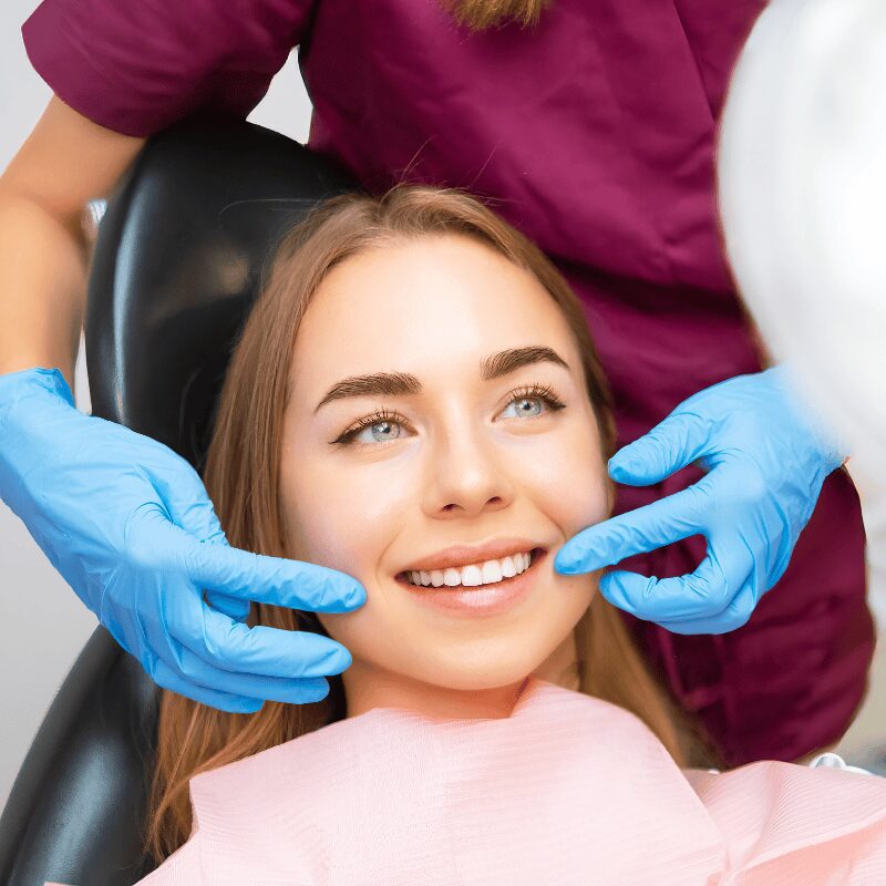 young woman smiling with veneers young woman smiling during veneer appointments