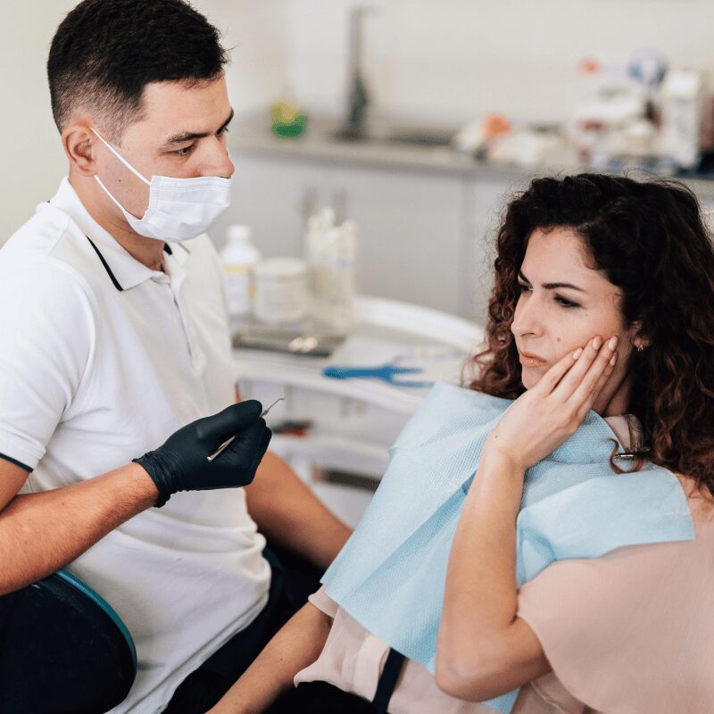 woman at the dentist clinic to examine tooth pain