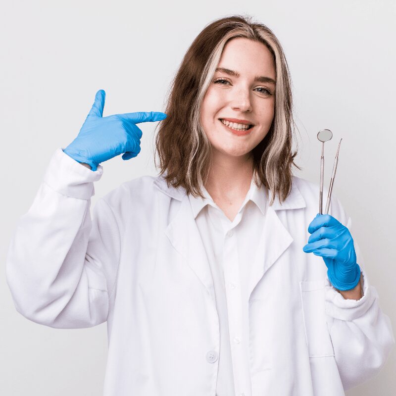 female dentist smiling confidently pointing broad smile