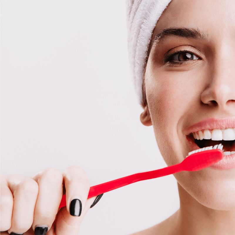 close-up-shot-half-face-cheerful-woman-brushing-her-teeth cheerful woman brushing her teeth