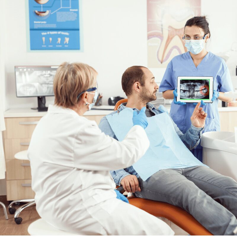 dental assistant showing xray of wisdom tooth dental assistant showing xray of wisdom tooth
