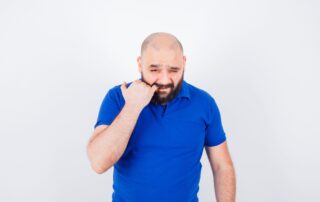 man wondering how long do dental implants hurt