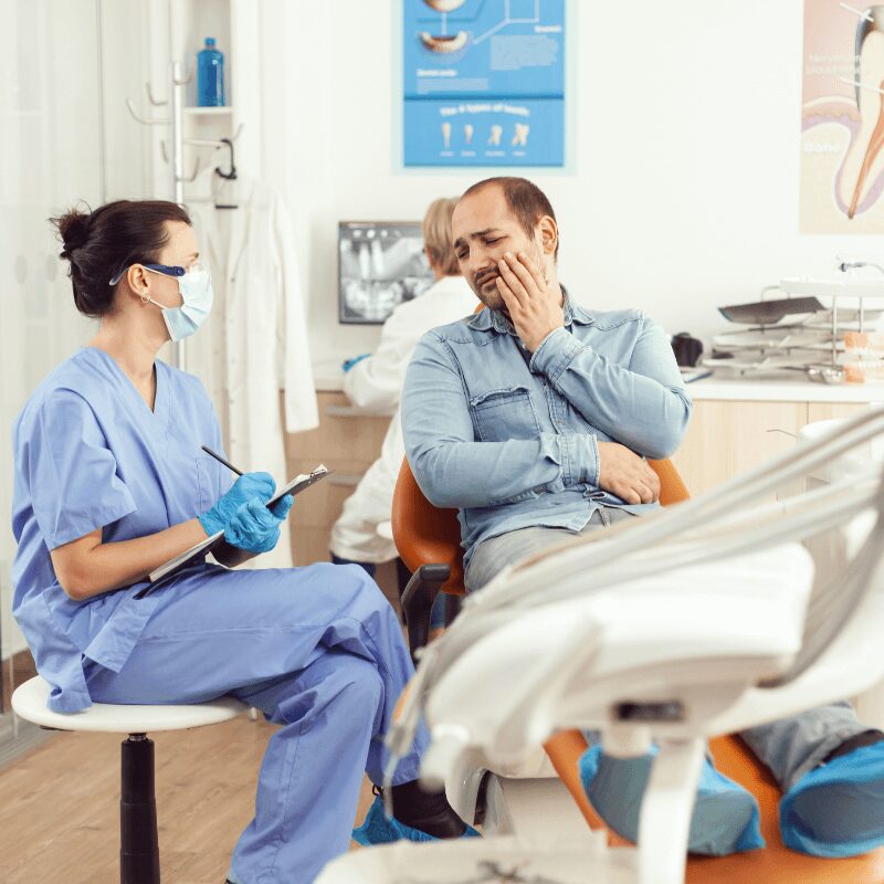 patient asking dental assistant if dental implants hurt dental patient asking dental assistant if dental implants hurt