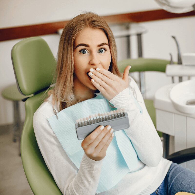 girl, teeth whitening patient, in dentist office