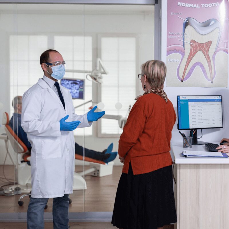 dentist discussing duration of appointment with patient dentist discussing duration of appointment with patient