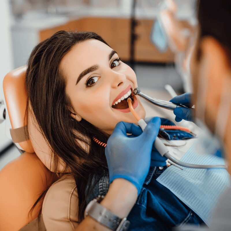 young-female-patient-visiting-dentist-office (1) young-female-patient-visiting-dentist-office