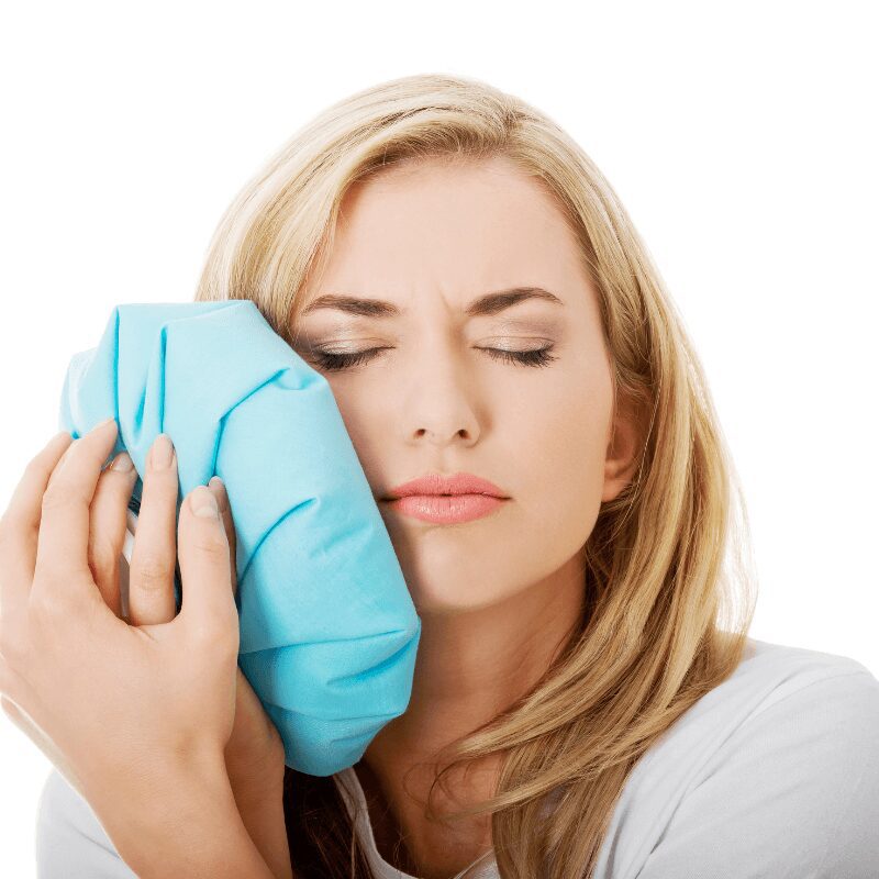 woman using cold compress to numb nerve pain woman using cold compress to numb nerve pain
