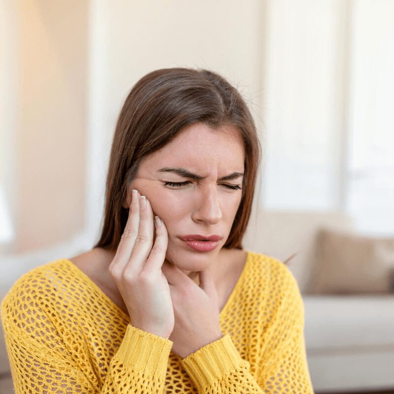 young woman experience tooth pain young woman experience tooth pain