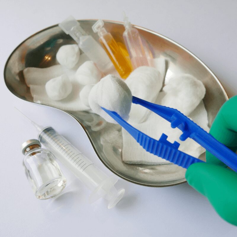 dentist applying cotton bud after wisdom tooth extraction on extraction site