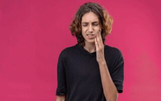 young male experiencing wisdom tooth eruption