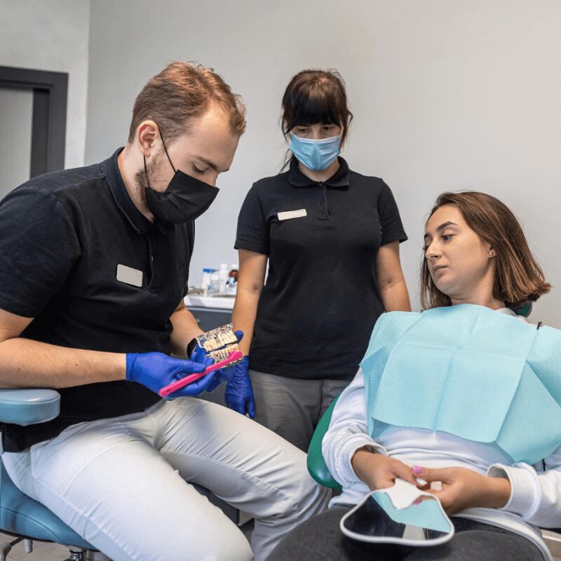 woman at the dentist office, dentist explaining oral teeth health to patient