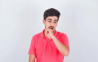 man experiencing sore inside mouth, cut on gums