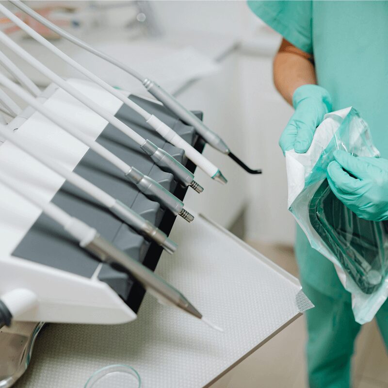 dental assistant scrub suit-opening-a-packet-of-sterile-dental tools