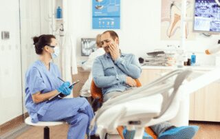 medical nurse examining patient pain writing dental problem clipboard