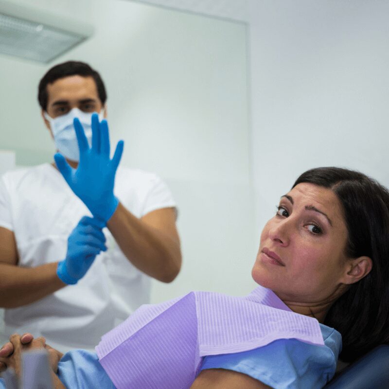woman sits in the dentist chair waiting for dental examination