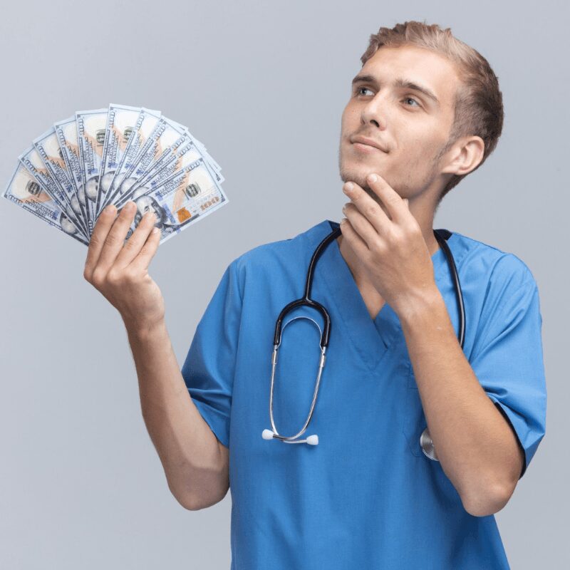 young-doctor-wearing-holding money wondering about cost of dental implant