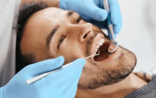 smiling young man sitting dentist having skipped dental cleaning before