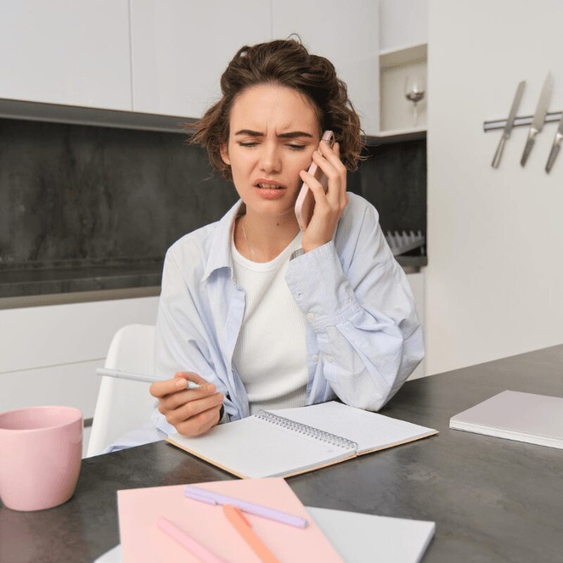 woman-working-remote-calling-dentist-experiencing-toothache