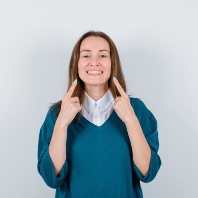 girl pointing her teeth looking happy