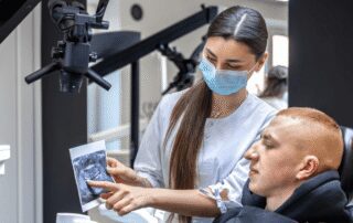 Dentist explaining root canal treatment to a patient at Advanced Dental Care of Indiana