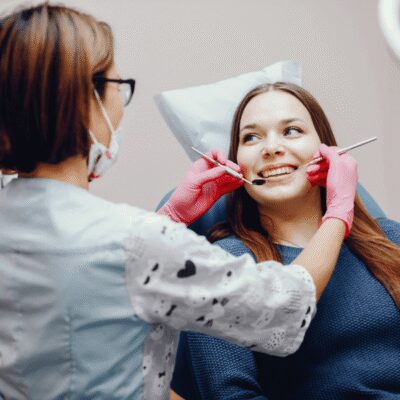 girl sitting dentists office smiling